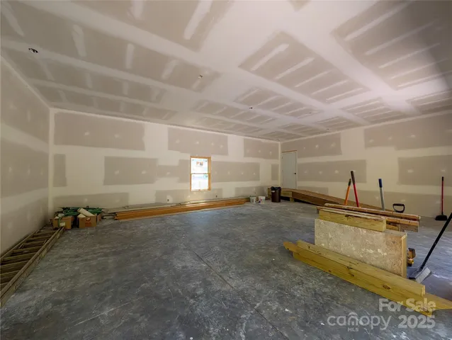 a room with gym equipment and a view of living room