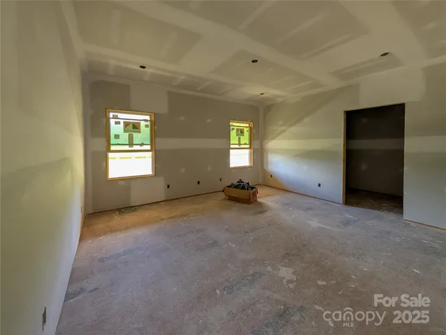 an empty room with windows and closet
