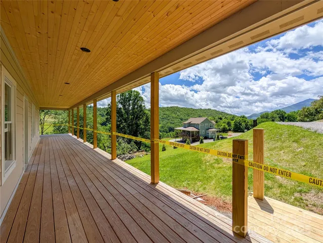 a view of balcony with wooden floor and fence