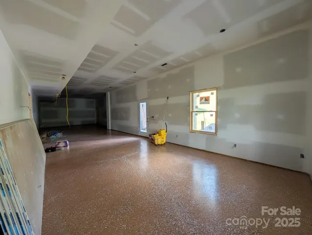 an empty room with furniture and a window