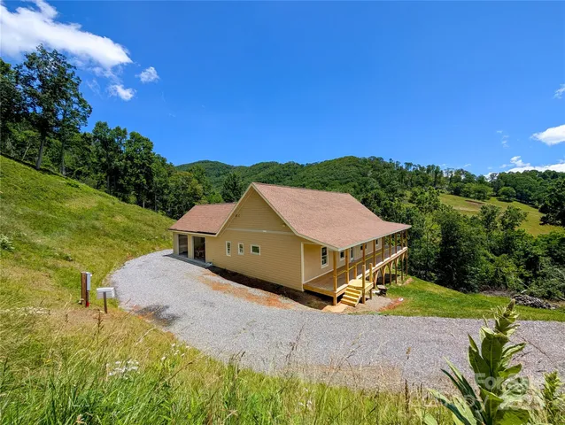 a aerial view of a house with swimming pool and a yard