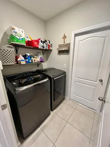 a dining room with furniture and a chandelier