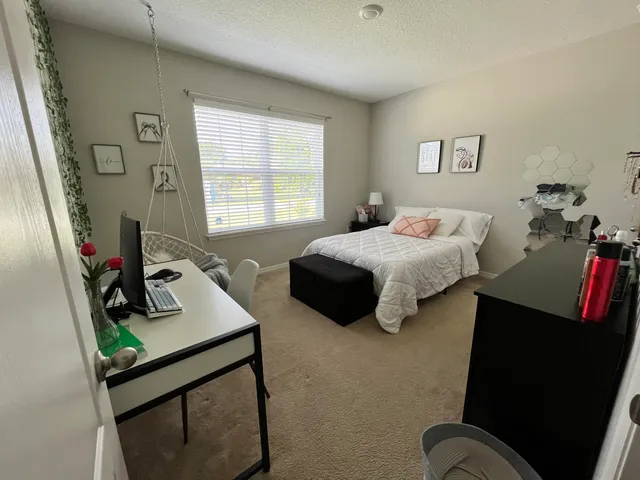 a bedroom with bed and a window