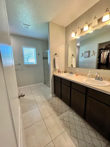 a spacious bathroom with a sink mirror and toilet