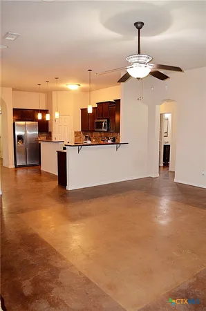 a view of a kitchen with a sink and chandelier