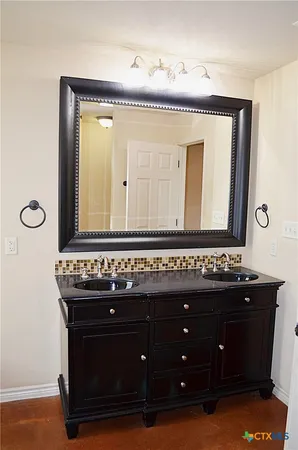 a bathroom with a sink vanity and a mirror
