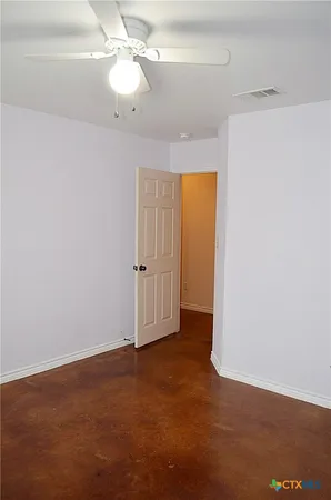 an empty room with a empty space and a ceiling fan