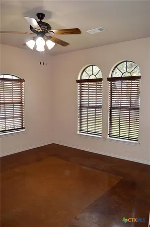 a view of a livingroom with a ceiling fan and window