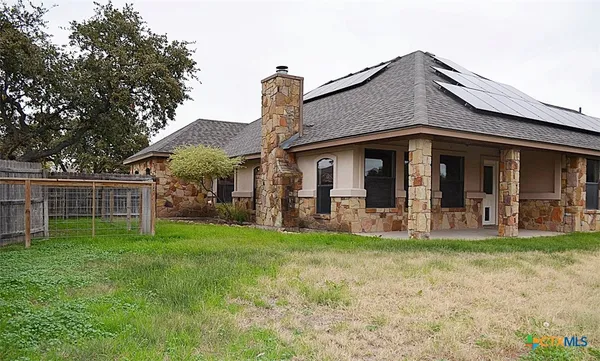 a view of a house with a yard and sitting area