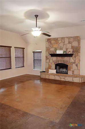 a view of an empty room with a fireplace
