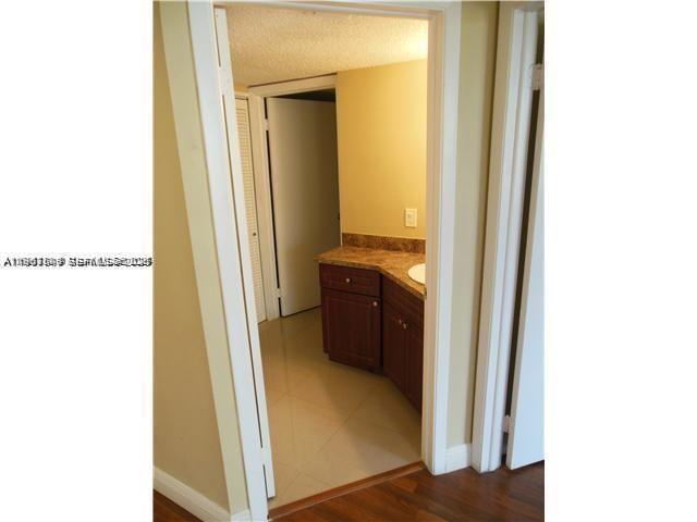 8335 Southwest 152nd Avenue, Unit B308 Miami, FL 33193 - Photo 7 of 9 a view of a bathroom from a hallway