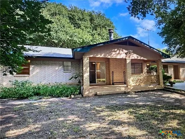a view of a backyard with large trees