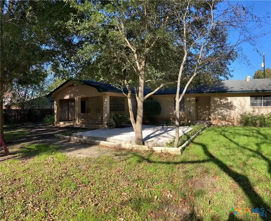 a view of empty room with wooden floor and fireplace
