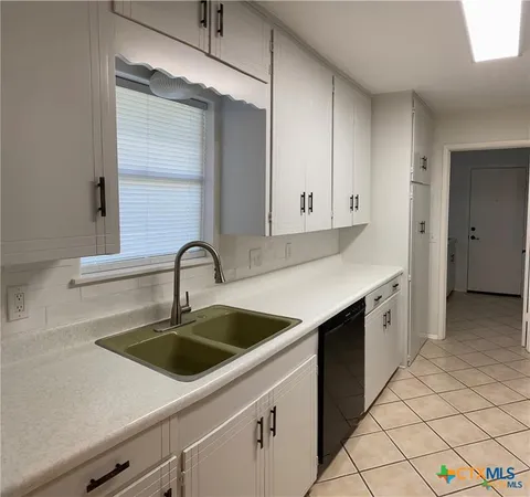 a kitchen with a sink and refrigerator