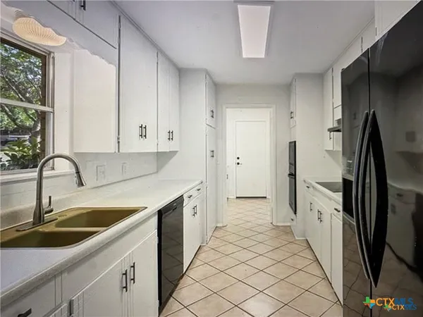 a view of a kitchen from the hallway