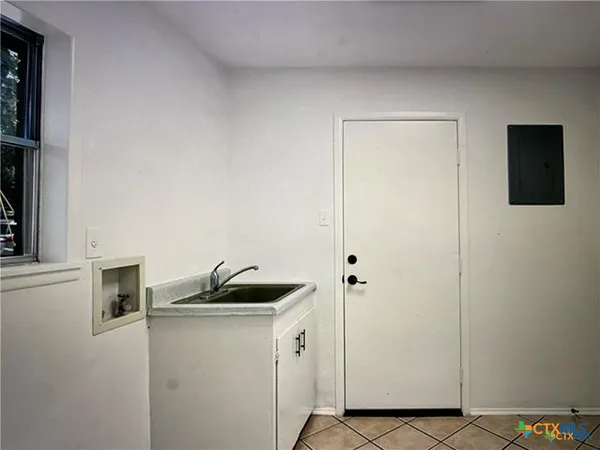 a kitchen with a sink and cabinets