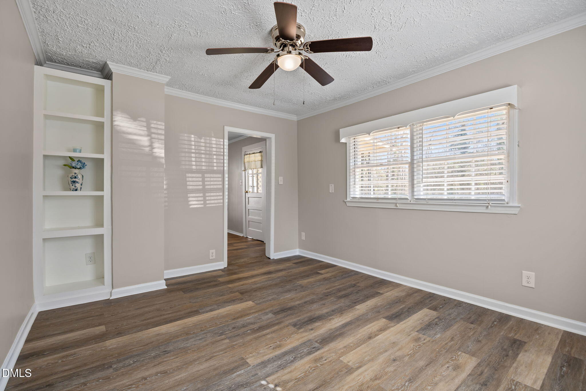 209 Weston Road Garner, NC 27529 - Photo 20 of 37 a view of an empty room with a window and wooden floor