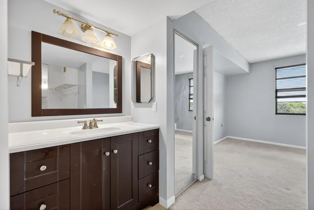 a bathroom with a double vanity sink and mirror