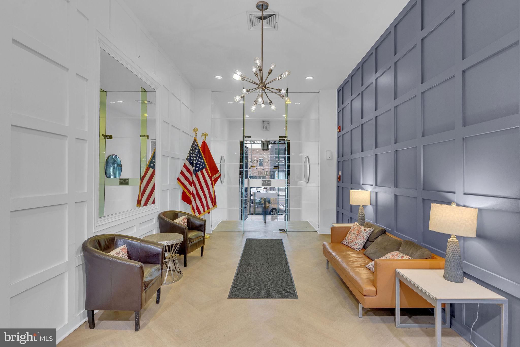 1100 South Broad Street, Unit 607B Philadelphia, PA 19146 - Photo 2 of 18 a living room with furniture and a chandelier