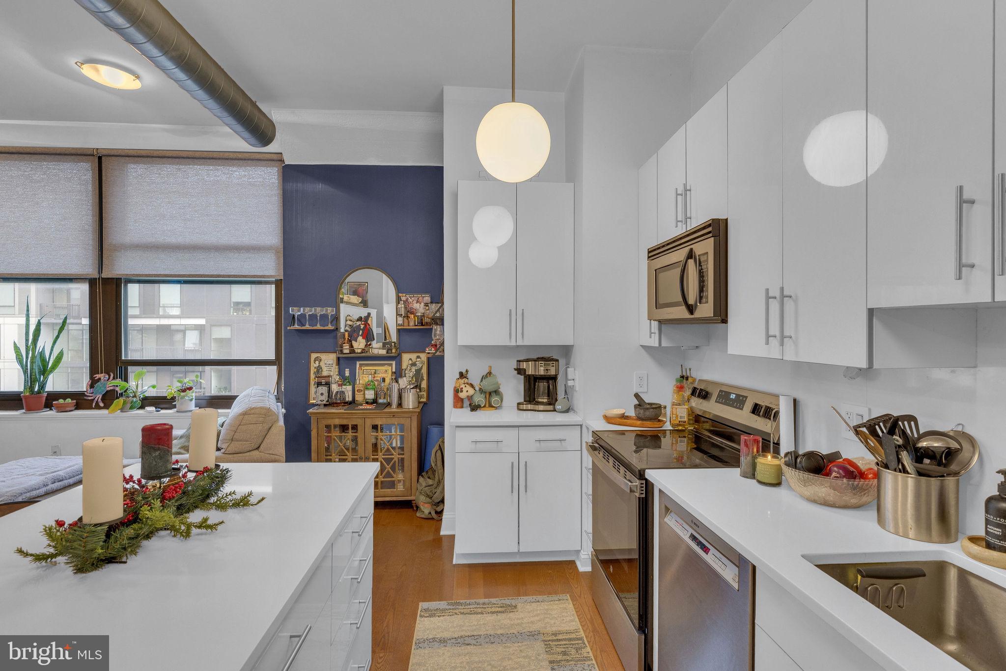 1100 South Broad Street, Unit 607B Philadelphia, PA 19146 - Photo 3 of 18 a kitchen that has a lot of cabinets a sink and a stove in it