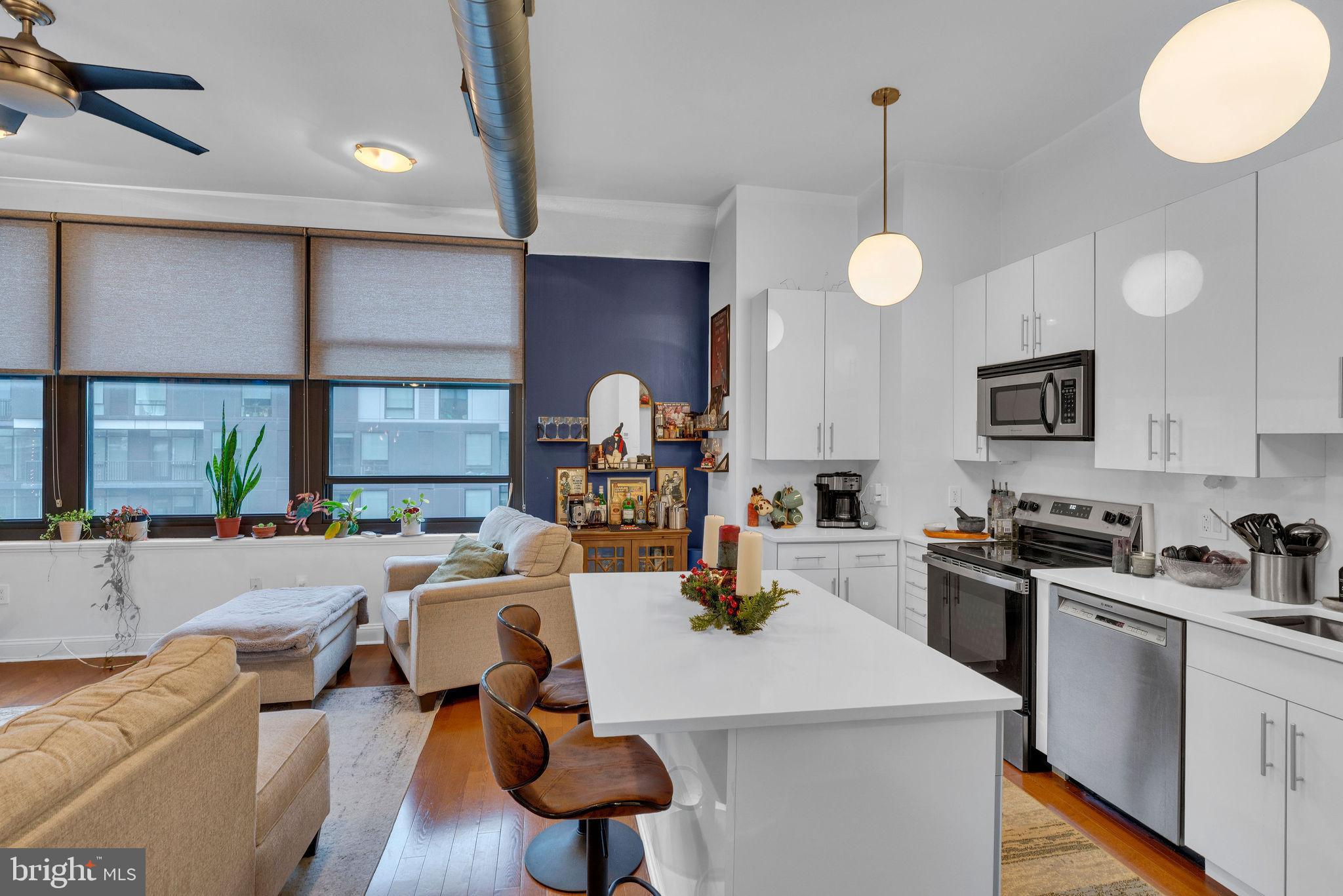 1100 South Broad Street, Unit 607B Philadelphia, PA 19146 - Photo 5 of 18 a open kitchen with sink microwave and cabinets