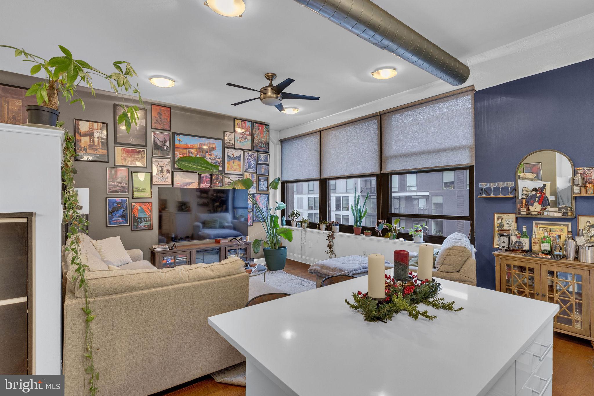 1100 South Broad Street, Unit 607B Philadelphia, PA 19146 - Photo 6 of 18 a living room with furniture a flat screen tv and a table