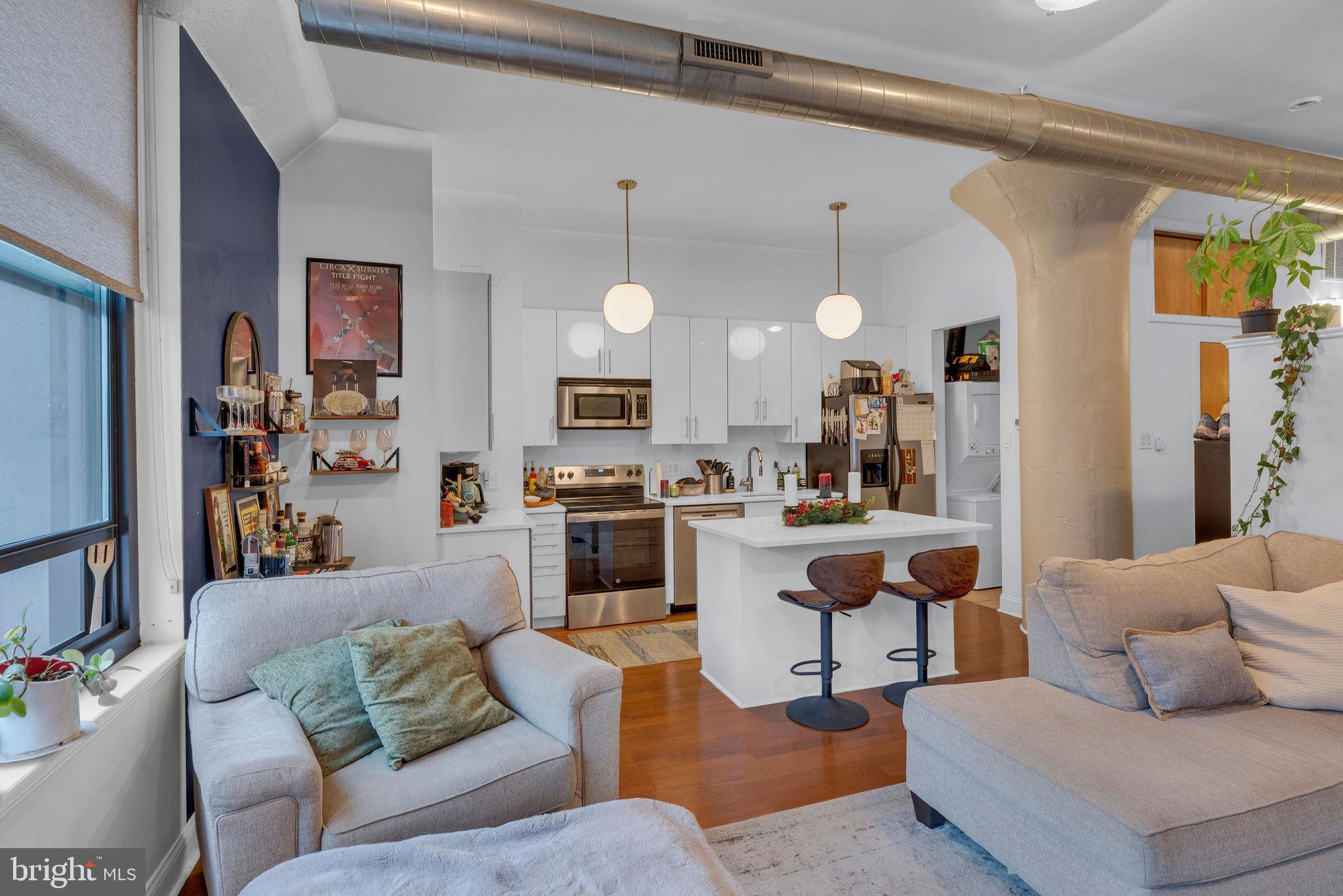 1100 South Broad Street, Unit 607B Philadelphia, PA 19146 - Photo 7 of 18 a living room with furniture kitchen view and a window