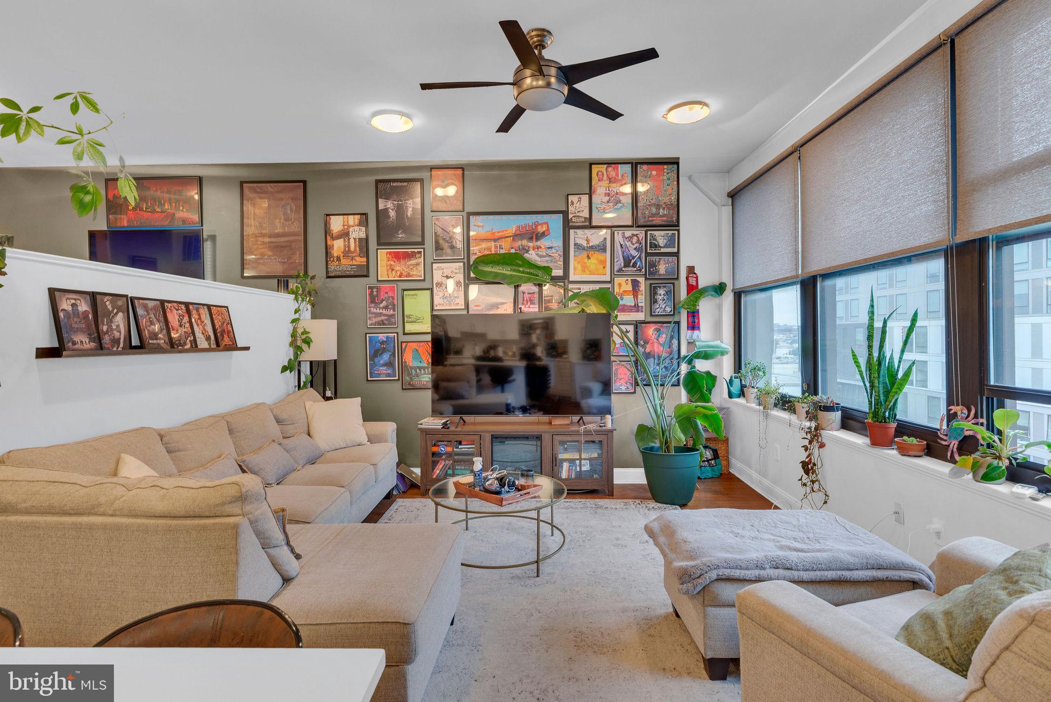 1100 South Broad Street, Unit 607B Philadelphia, PA 19146 - Photo 8 of 18 a living room with furniture large window and flat screen tv
