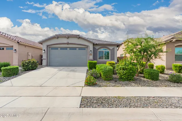 a front view of a house with a garden