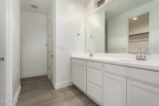 a bathroom with a double vanity sink and a mirror