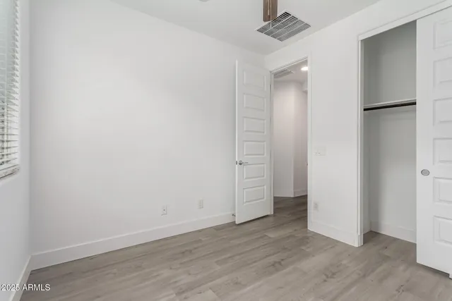 an empty room with wooden floor