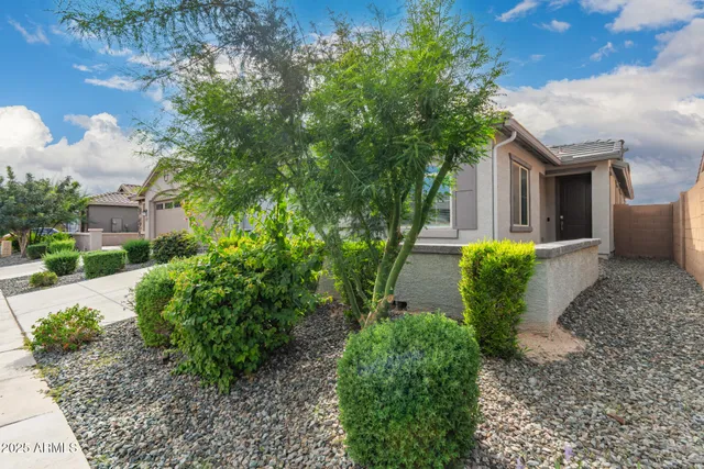 a front view of a house with garden