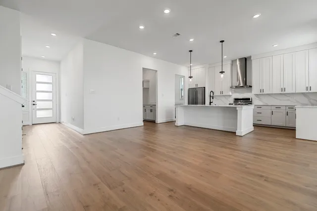 a view of kitchen with stainless steel appliances refrigerator oven and cabinets