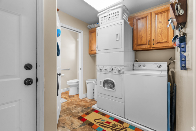 5727 South 3550th Street West Roy, UT 84067 - Photo 23 of 49 Laundry area with rich wood cabinetry