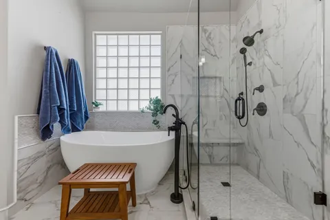 a bathroom with a bathtub and shower