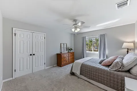 a bedroom with a large bed and a chandelier