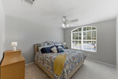 a bedroom with a bed and window