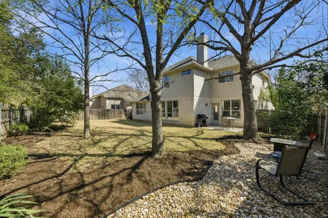 a view of a house with backyard and sitting area