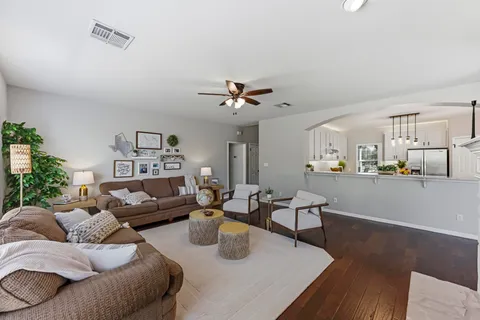 a living room with furniture and view of kitchen