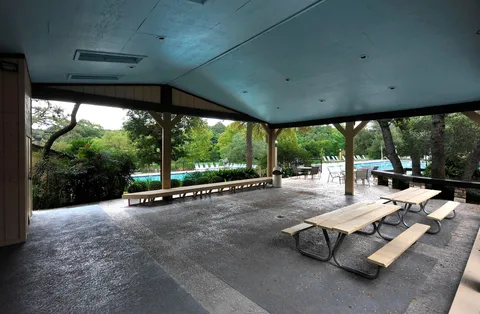 a room with pool table and chairs