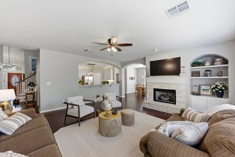 a living room with furniture a fireplace and a flat screen tv