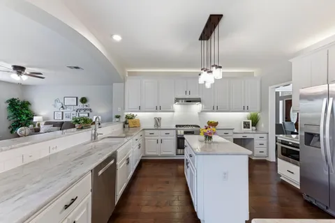 a kitchen with sink cabinets and refrigerator