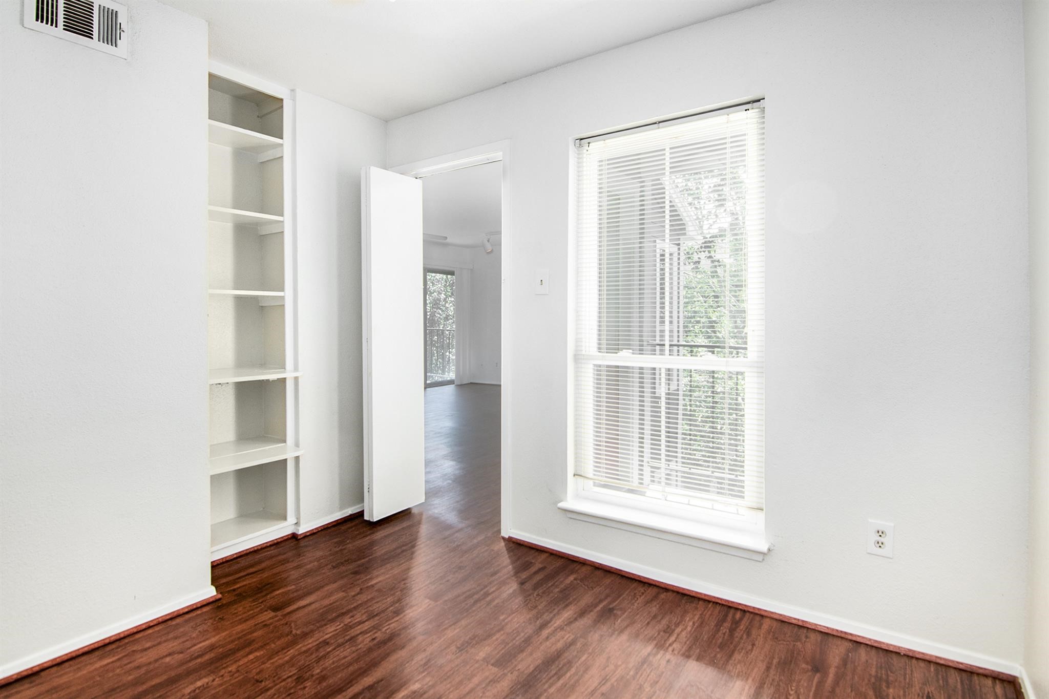 18519 Egret Bay Boulevard, Unit 1708 Webster, TX 77058 - Photo 12 of 27 a view of an empty room with a window and wooden floor