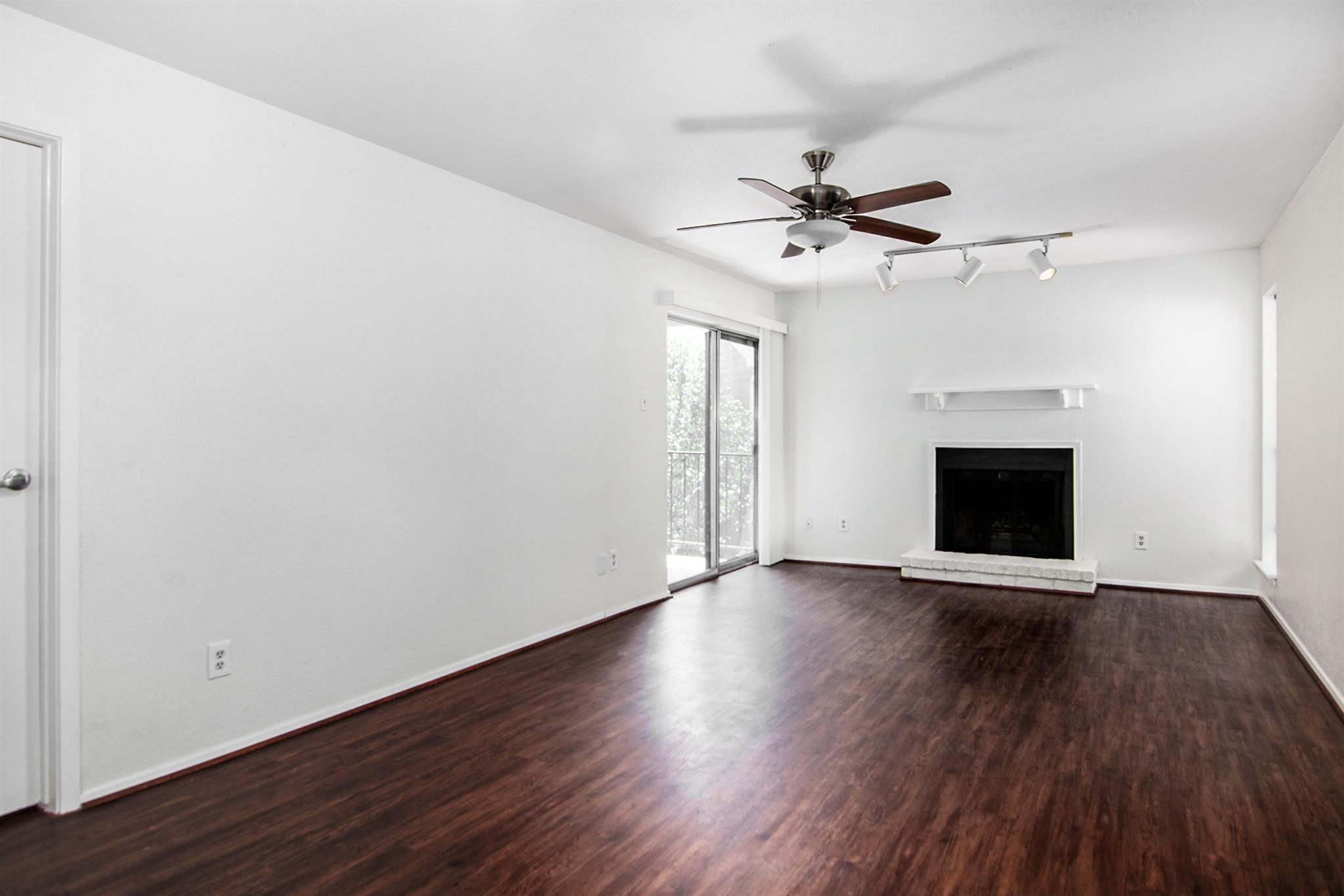 18519 Egret Bay Boulevard, Unit 1708 Webster, TX 77058 - Photo 4 of 27 an empty room with wooden floor ceiling fan and windows