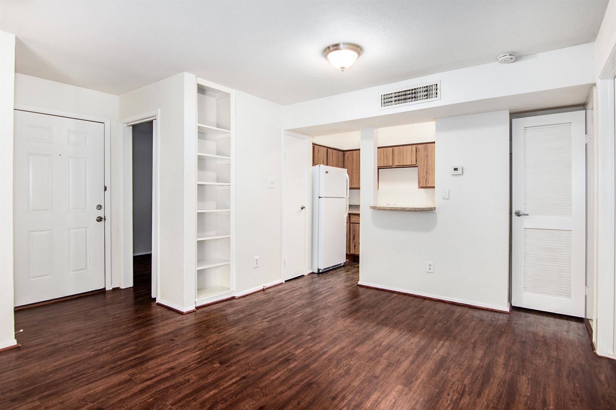 18519 Egret Bay Boulevard, Unit 1708 Webster, TX 77058 - Photo 6 of 27 an empty room with wooden floor & windows and bathroom