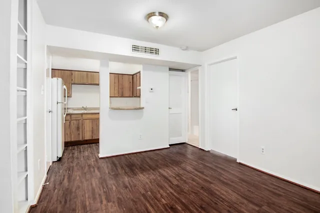 a view of a kitchen with wooden floor and a sink