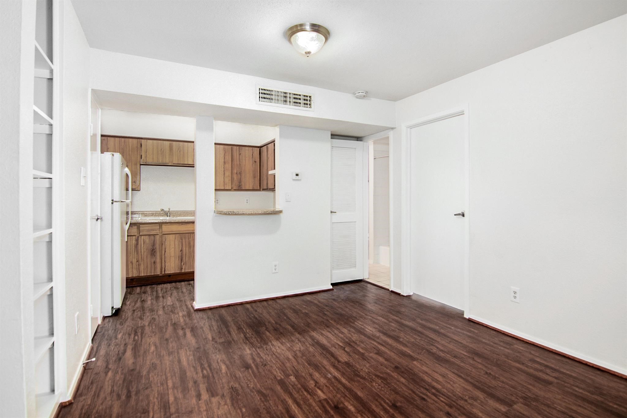 18519 Egret Bay Boulevard, Unit 1708 Webster, TX 77058 - Photo 7 of 27 a view of a kitchen with wooden floor and a sink