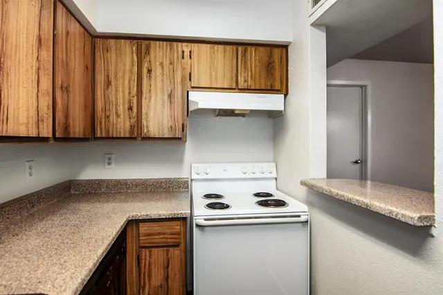 a kitchen with granite countertop cabinets washer and dryer