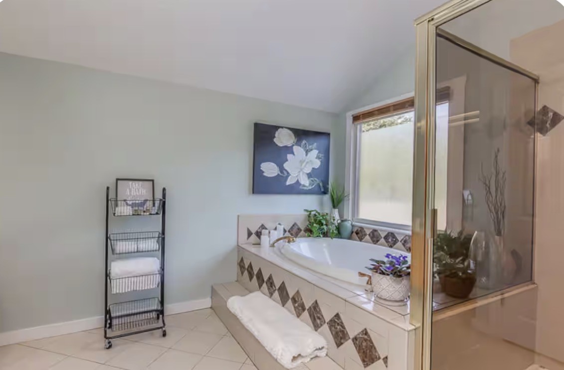 1437 Dividing Ridge Road Goodlettsville, TN 37072 - Photo 11 of 36 a bathroom with a tub sink and mirror