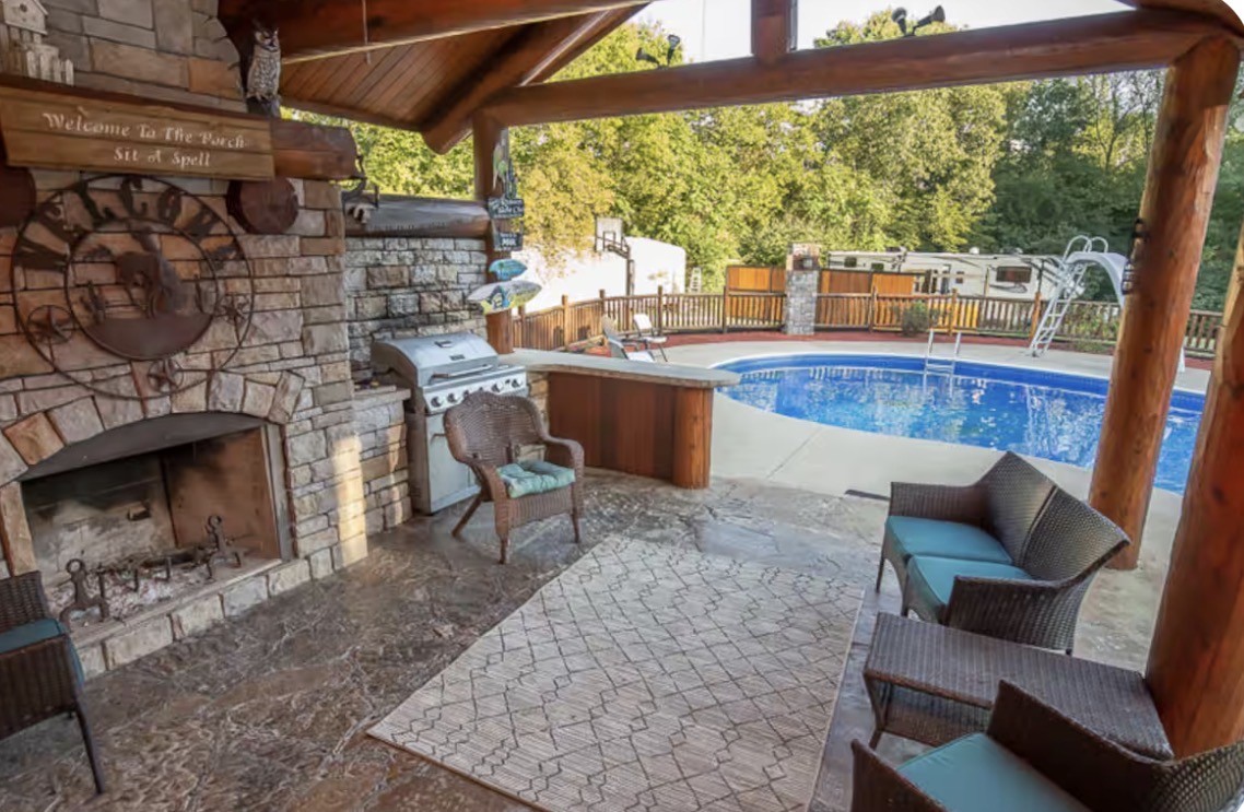 1437 Dividing Ridge Road Goodlettsville, TN 37072 - Photo 33 of 36 a living room with couch a fireplace and a floor to ceiling window